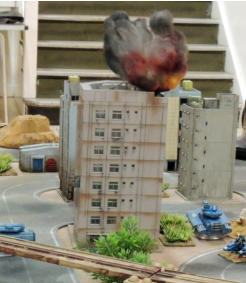 Building on fire after TAS buzzbomb team come under fire from Slammers Combat Cars