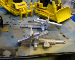 White metal guns minus the wheels and dozers