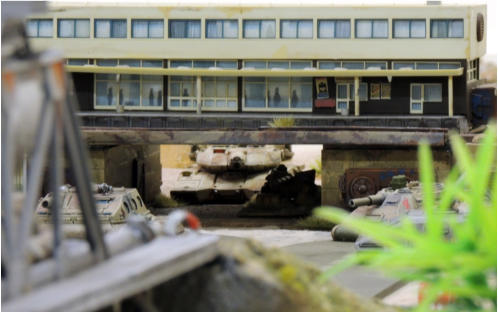 An Antargran Zentaur in wait under teh monorail station flanked by two Flaming Sword tank destroyers