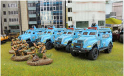Four police trucks and an explosive truck. The Police trucks have lighter weathering - less in in the Future - plus light dry brushing