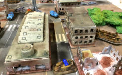 Tank destroyer with a knocked out main gun deliberately blocks the street while the crew make a run for it...