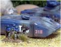 Infantry deploy from a HALO HSAG16 Heavy APC armed with medium ATGWs and a rapid-fire, remote mounted, 2cm powergun