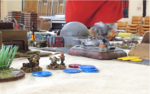 A Blower tank at speed on the road while Sincanmo infantry take up firing positions