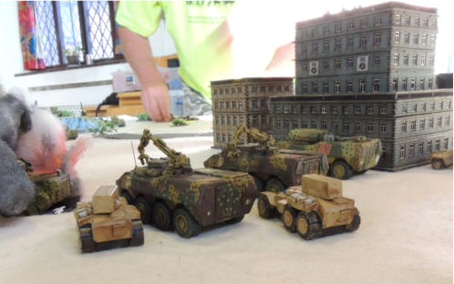 Thunderbolt recovery vehicles wait with Hashemite missile launchers while other vehicles burn