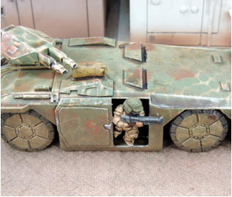 Assault team member in full armour exits from an M577