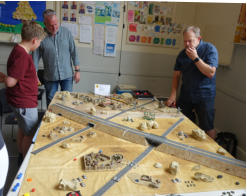 Tony Francis and players survey the table
