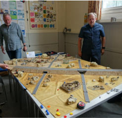 Tony Francis and players survey the table