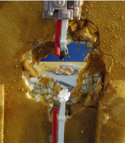 hole in the wall showing rebar and air-con unit once the sand had been added