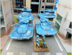 Two Wraiths and two Ghost tanks led through city streets by an infantry unit