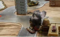 A burning Combat Car with a Buran and a Slammers Jeep in the distance
