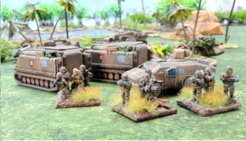 Infantry in heavy armour carrying coil guns, supprt weapons and buzzbombs deply from two Kunitsa APCs and a Belette heavy recce vehicle with missile system.